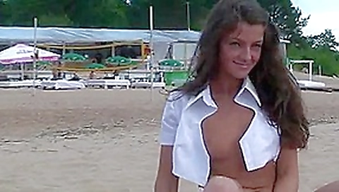 Tanned Russian brunette gets nude on the beach