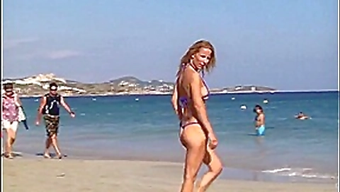 Hot blonde milf posing on public beach in string bikini Hot blonde milf posing on public beach in string bikini
