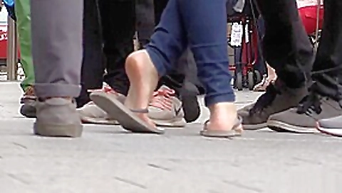 Candid barefoot shoeplay in flip-flops