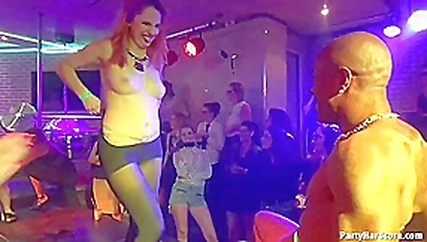 Kinky ladies are teasing a guy who is tied up on the stage, in the night club Kinky ladies are teasing a guy who is tied up on the stage, in the night club