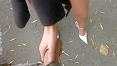 Cute brunette Lotty gets down on her knees to suck a bone in a public park