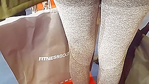 Two candid fit asses in grey yoga pants walking