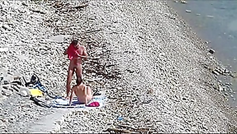 Couple fucked on a public beach while as people walked near